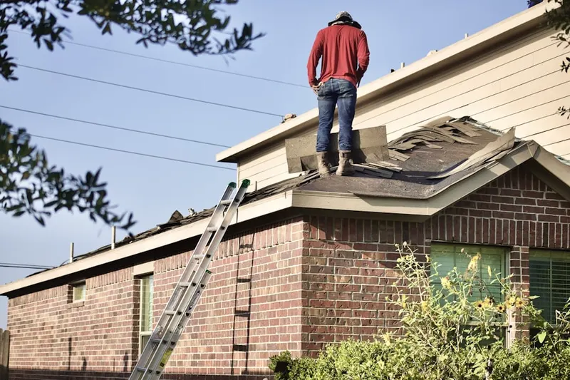 Professional roofer working on a residential roof in Lawrence Township